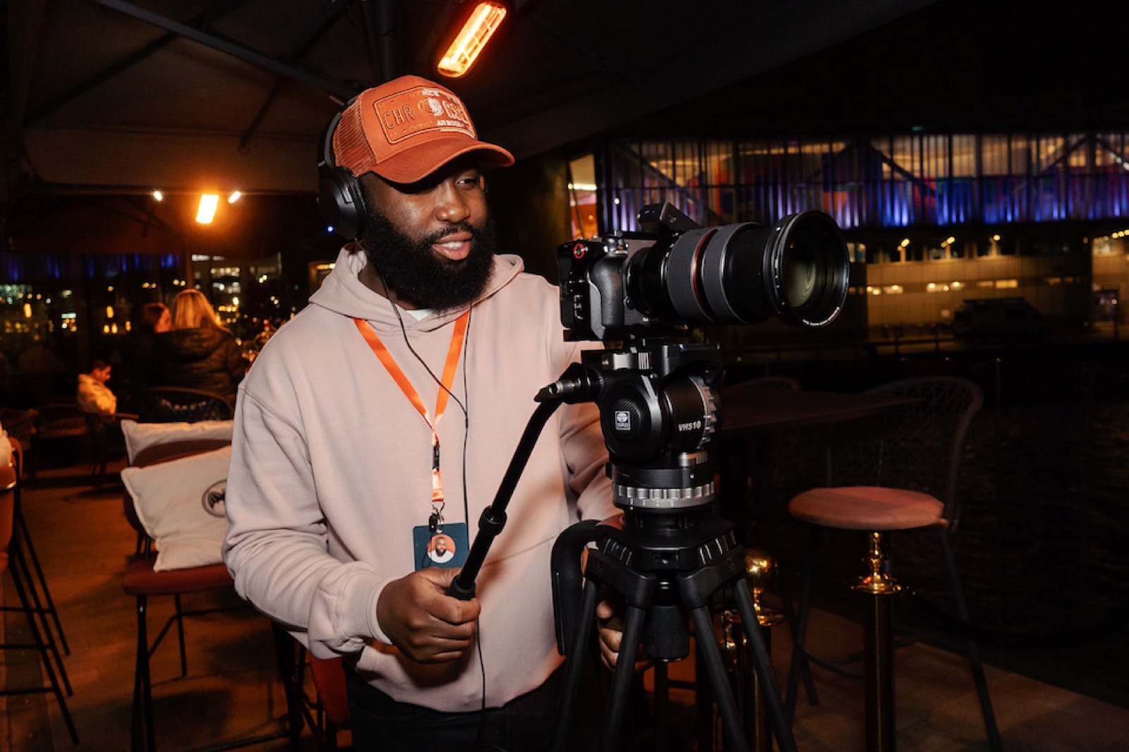 An mtb studios camera operator setting up a shot at an evening event