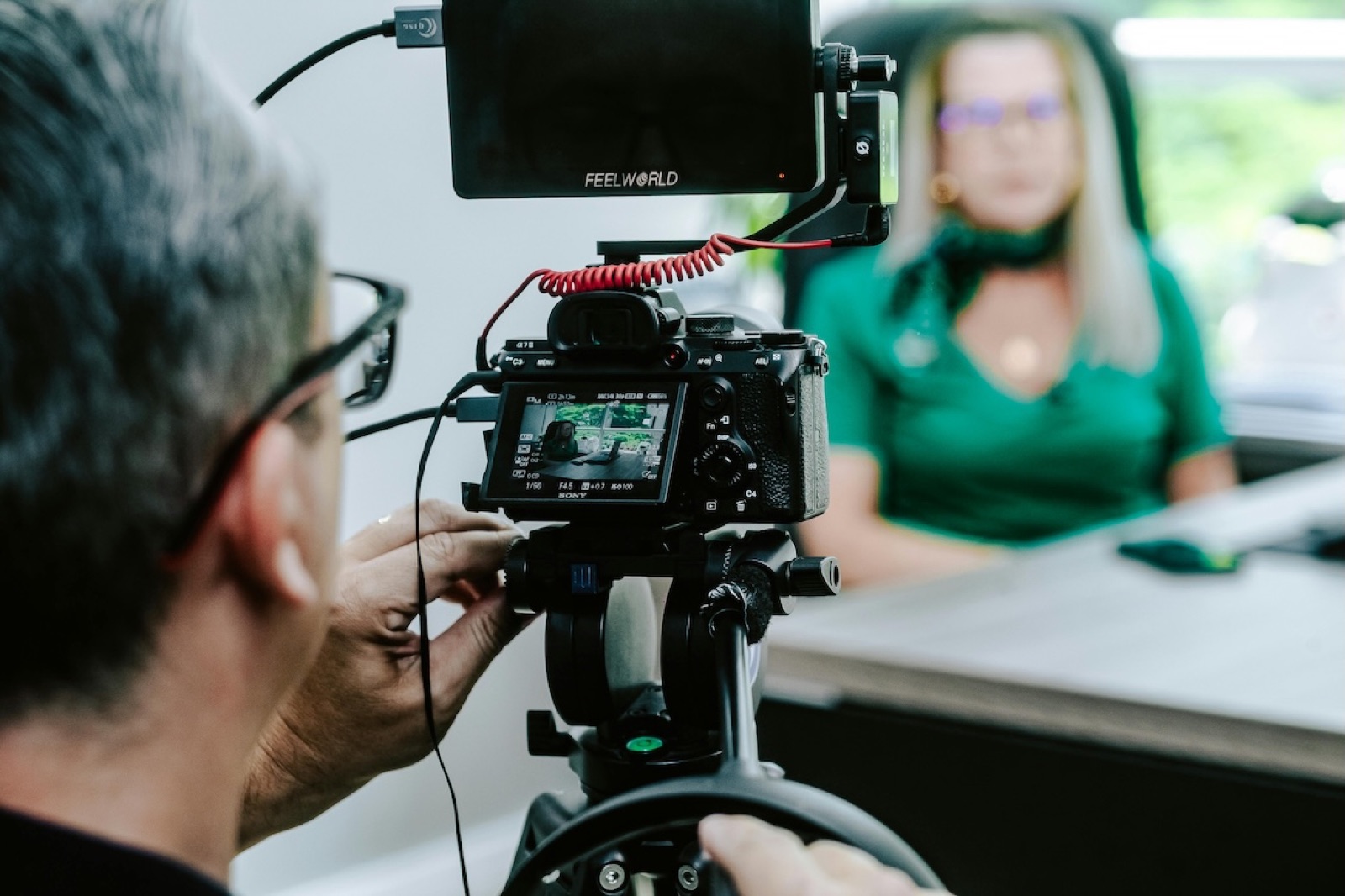 A camera operator filming a brand interview